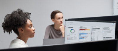 A person sitting at a desk looking at a computer screen.