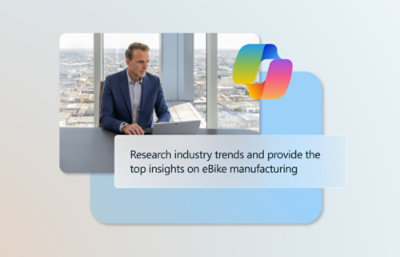 一位身着西装的男士坐在桌前，面前放着一台笔记本电脑，正在分析电动自行车制造行业的研究趋势。