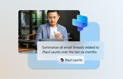 A man holding a cup and looking at a screen displaying email summaries for Raul Laurits.