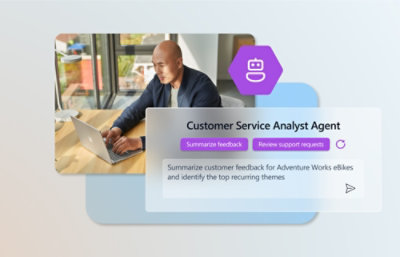 A man sitting at a table with a laptop.