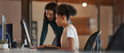 A man and woman using a computer and discussing.