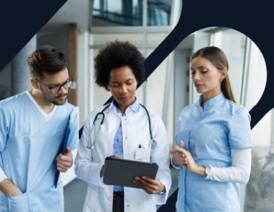 A group of medical professionals looking at a tablet