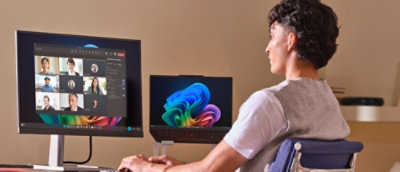 A man sitting in a chair looking at a computer screen.
