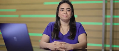 A woman wearing a purple shirt is visible.