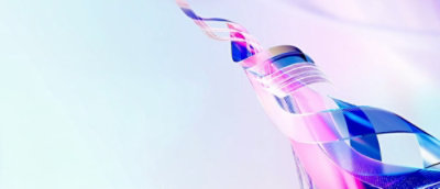 A close-up of a bottle with a blue and pink swirly design.