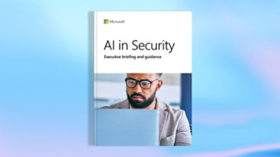 A book cover titled ‘AI in Security: Executive briefing and guidance’ featuring the Microsoft logo and a person working on a laptop in the background