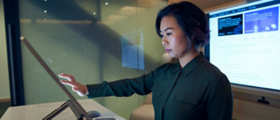 緑色のシャツを着た、コンピューティングを使っている女性