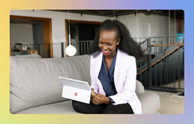 A woman looking at the laptop and smiling