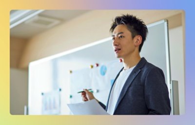 A man explaining while standing in front of white board