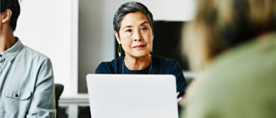 A woman looking at a computer screen.