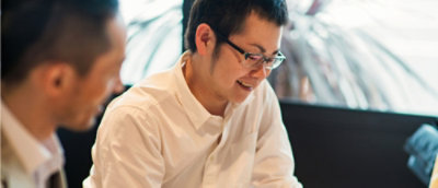 Two man working on the laptop and discussing