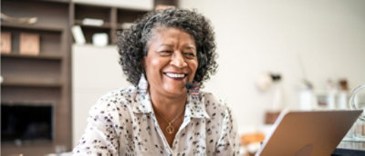 An old woman looking at the camera and smiling