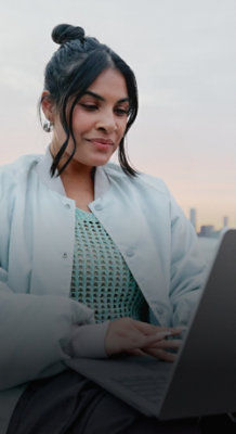 A woman is looking at the laptop.