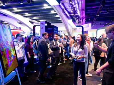 A group of people in a room at a convention.