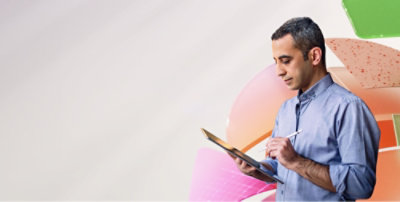 Un hombre de pie con su tableta en brazos.