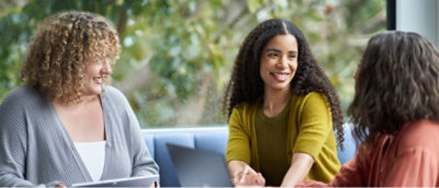 A group of woman sitting at a table and discussing.