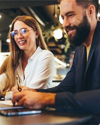 A man and woman smiling at each other.