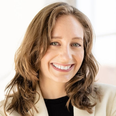 Portrait of a person with shoulder-length hair, bright smile.