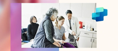 A group of people looking at a laptop.