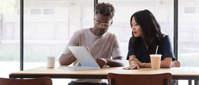 Un homme et une femme regardant un ordinateur portable.