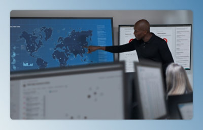 A man pointing at a map displayed on a screen.