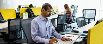 A person sitting at a desk using a computer.