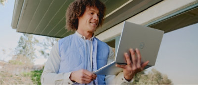 A person holding a laptop.