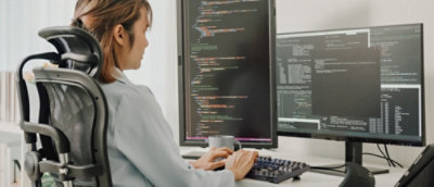 A person sitting at a desk working on a computer.