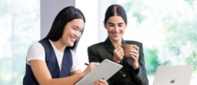 A couple of women looking at a tablet.