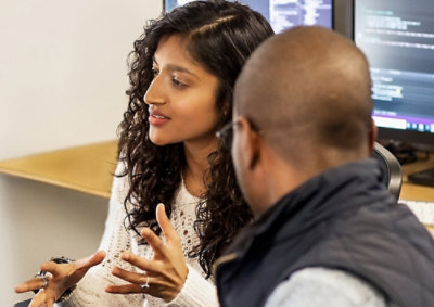 A man and a woman looking at a computer screen.