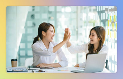A woman giving a high five to another woman.