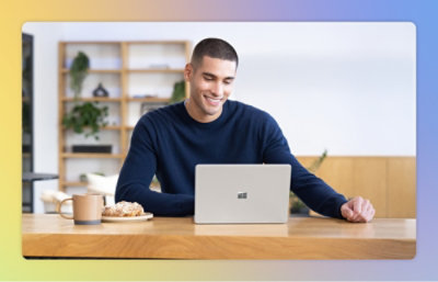 A man sitting at a table with a laptop.