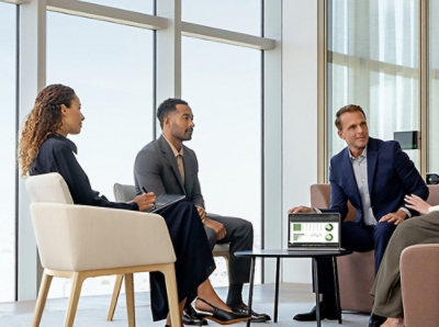 A group of peole sitting around the table and discussing.