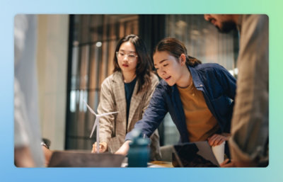 A group of people looking at a laptop