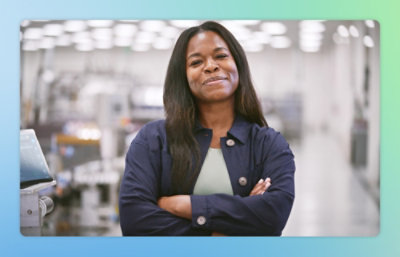 A women wearing blue shirt looking at a camera