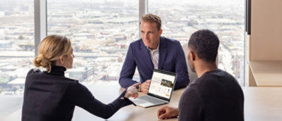 A person sitting at a desk using a laptop.