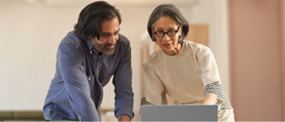 A man and a women working on laptop.