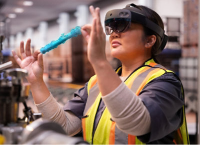 A woman wearing a safety vest and goggles.