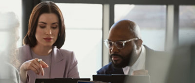 A man and woman looking at something.