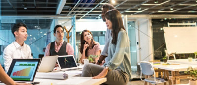 A man wearing glasses working on the laptop