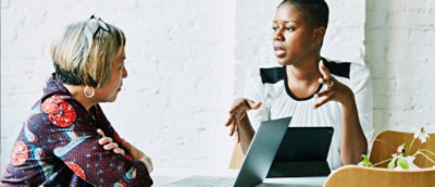 A man and a woman looking at a computer screen.