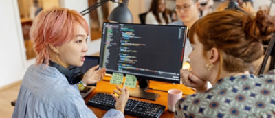 A group of people looking at a computer screen.