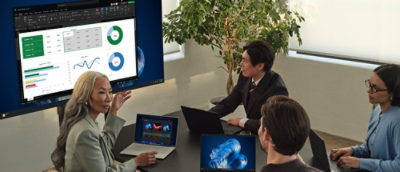 A group of people looking at a desktop