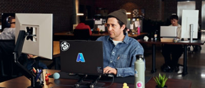 A person looking at a computer monitor.