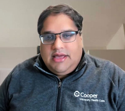 A man with glasses sitting on a couch.