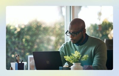 Person working at a desktop computer in an office environment.