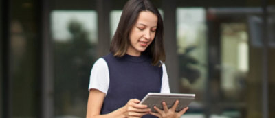 A person holding a tablet.