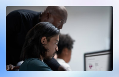 Employees working on computer in workplace.