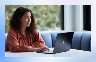 Person sitting in booth looking at laptop