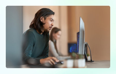 Person using a computer at a desk.